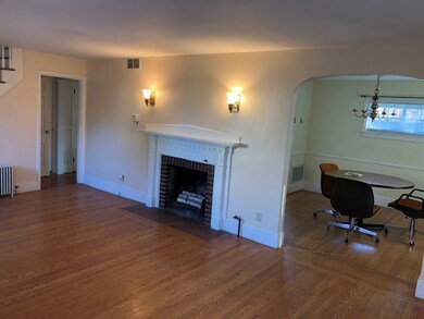 Living room w/arched doorway to dining