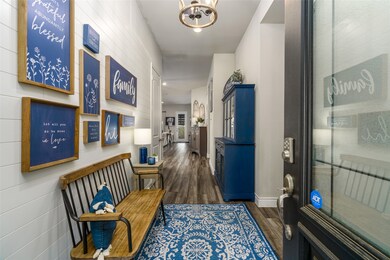Large entryway with Shiplap and custom chandelier