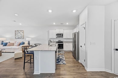 Kitchen featuring open floor plan, a kitchen break