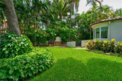 Front left yard with built in outdoor fireplace, courtyard access to primary suite sitting area and gate to back yard.