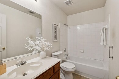 Full bathroom with tiled shower / bath combo, tile