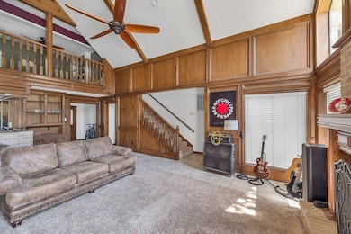 FAMILY ROOM - this open space features a cozy fireplace, vaulted ceiling with wood beams and a wet bar.