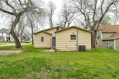 Rear view of property featuring central AC unit an