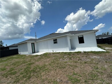Rear view of house featuring stucco siding and a p