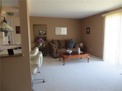 Beautiful living room with balcony & neutral dcor!