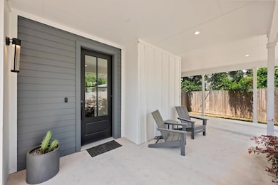 Property entrance featuring fence, a patio, and b