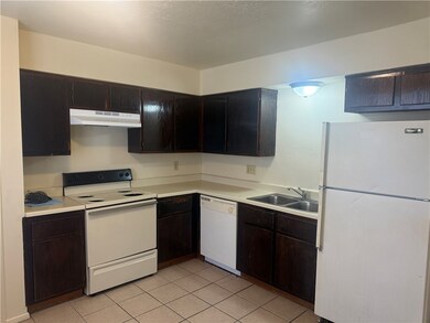 Kitchen featuring white appliances, under cabinet