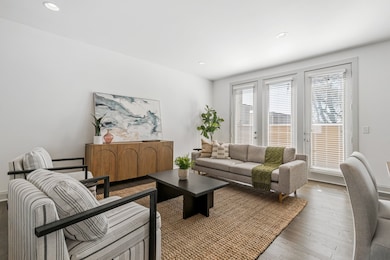 Living area with doors leading to balcony.