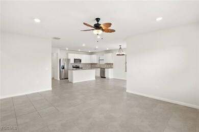 Unfurnished living room featuring a ceiling fan and recessed lighting