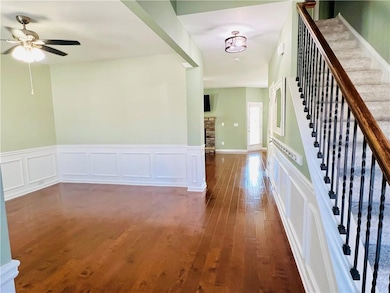 Foyer entrance featuring a wainscoted wall, a deco