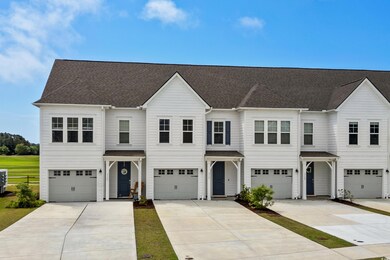View of front of property featuring a garage, driv