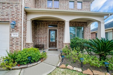 An exceptionally spacious front porch features Craftsman style arches and posts.