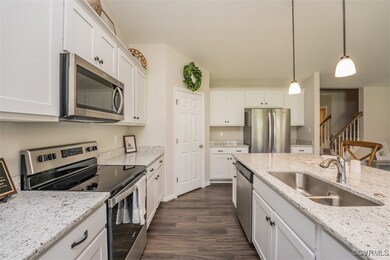 Kitchen featuring decorative light fixtures, white