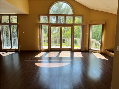 New hardwood floors grace the cathedral ceiling li