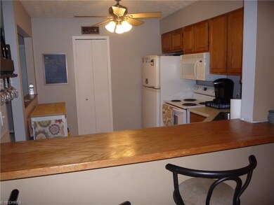 Open floor plan has seating at kitchen bar which o
