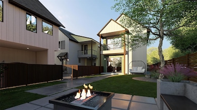 Back of house with an outdoor fire pit, a balcony