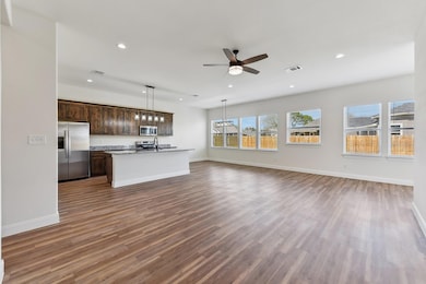 Kitchen featuring visible vents, open floor plan,