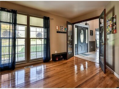 PRETTY FRENCH DOORS OPEN ONTO LIVING ROOM WITH GLE