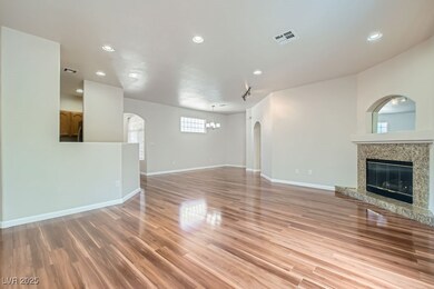 Unfurnished living room with baseboards, light woo