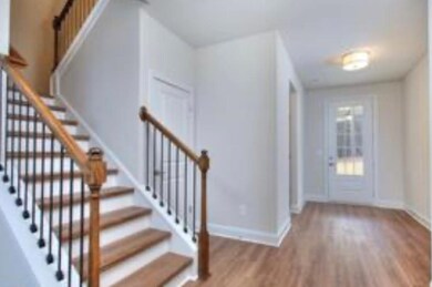 Foyer entrance featuring baseboards, wood finished