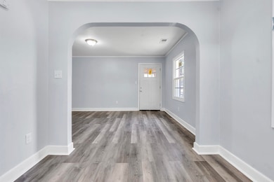 Foyer entrance featuring arched walkways, wood fin
