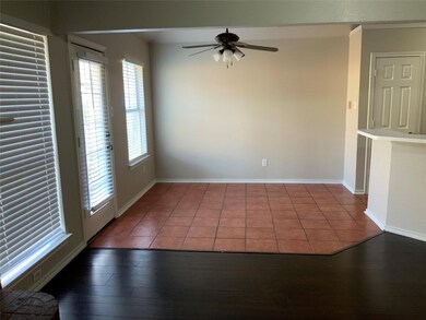 Tiled empty room with baseboards and a ceiling fan
