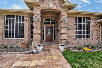 Entrance to property featuring brick siding