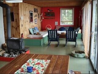 Living room with wood stove & built-ins.