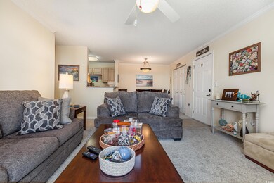 Living room featuring crown molding, carpet floors