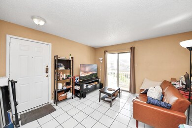 Cozy living room with tiled floors, neutral walls,