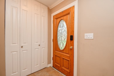 Welcoming entryway with a warm wood front door fea