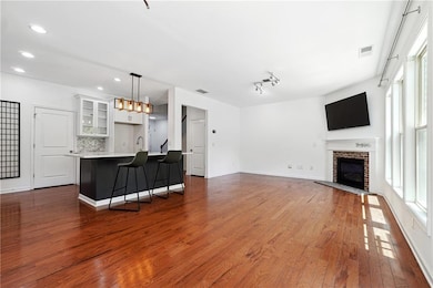 Living area with a brick fireplace, dark wood-type
