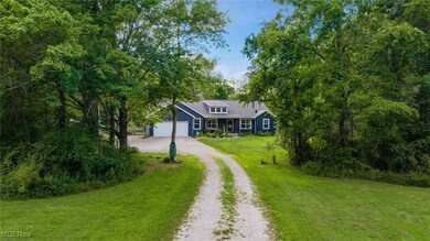 View of front of house featuring driveway, a front yard, and an attached garage