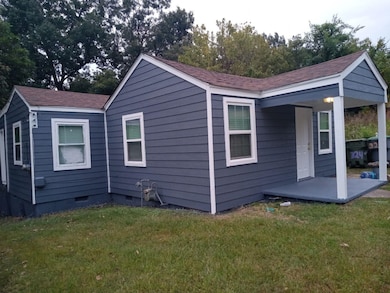 Rear view of property featuring a yard