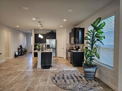 Kitchen featuring decorative light fixtures, appli