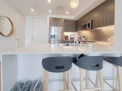 Kitchen with stainless steel appliances, a penins