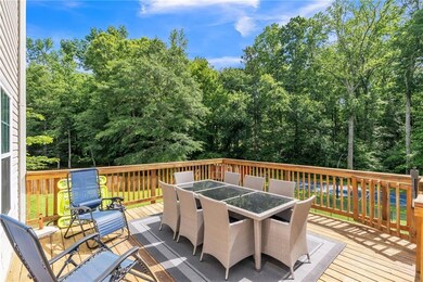 Deck featuring outdoor dining space and view of scattered trees