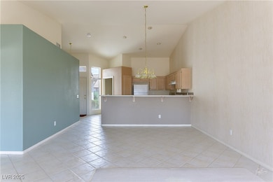Kitchen featuring light brown cabinets, freestandi