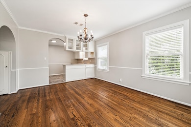 Dining room looking into kitchen. Notice the archway leading into the living room. There is extra storage on the inside of the archway on both sides.
