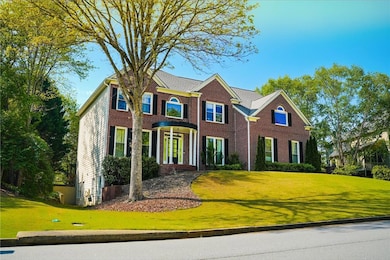 Colonial house with a front yard and brick siding