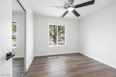 Spare room with wood finished floors, ceiling fan,