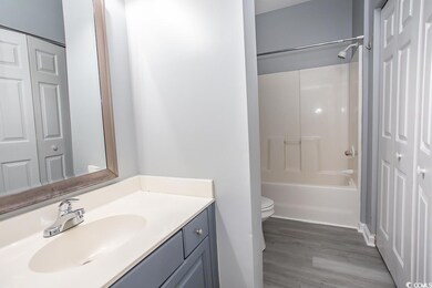 Full bathroom featuring vanity, toilet, wood-type 