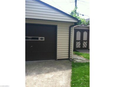 Decorative Shed accompanies two car garage.