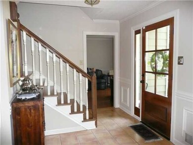 Richly stained front door opens to tiled & lovely 