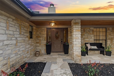 Doorway to property featuring stone siding and a 