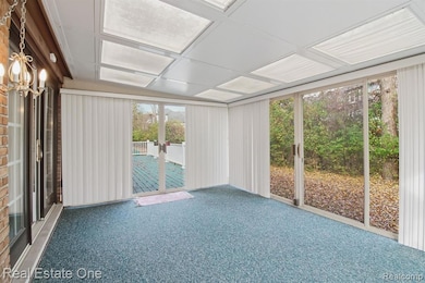 Unfurnished sunroom featuring carpet flooring
