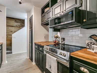 Kitchen with wooden counters, stainless steel appl