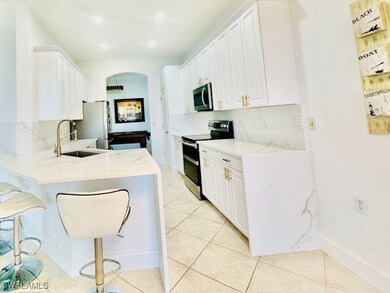 Kitchen with light tile patterned floors, a breakf