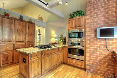 The kitchen boasts hardwood floors, granite counte