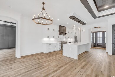 Kitchen featuring high end stainless steel range, 